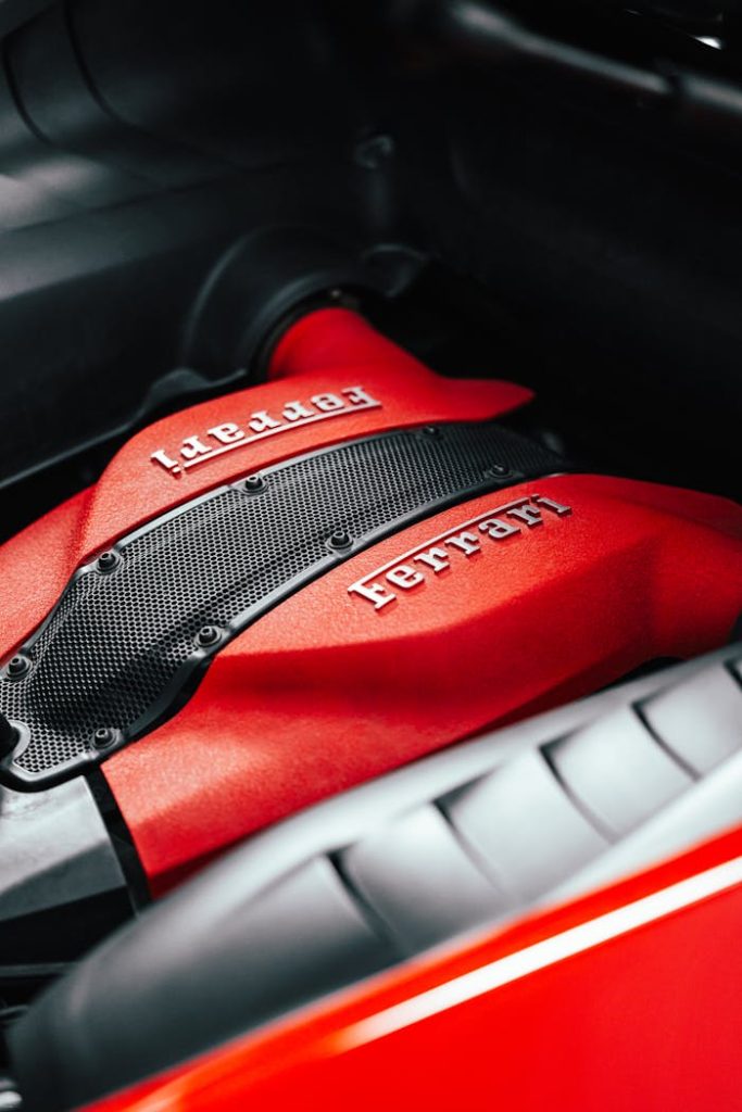 Detailed shot of a red Ferrari engine, showcasing automotive engineering excellence.